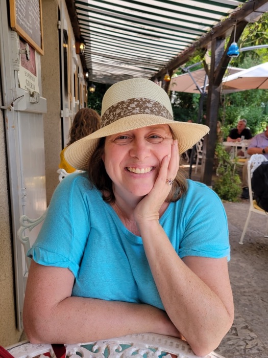 Kris enjoying an outdoor caf&eacute; during her travels